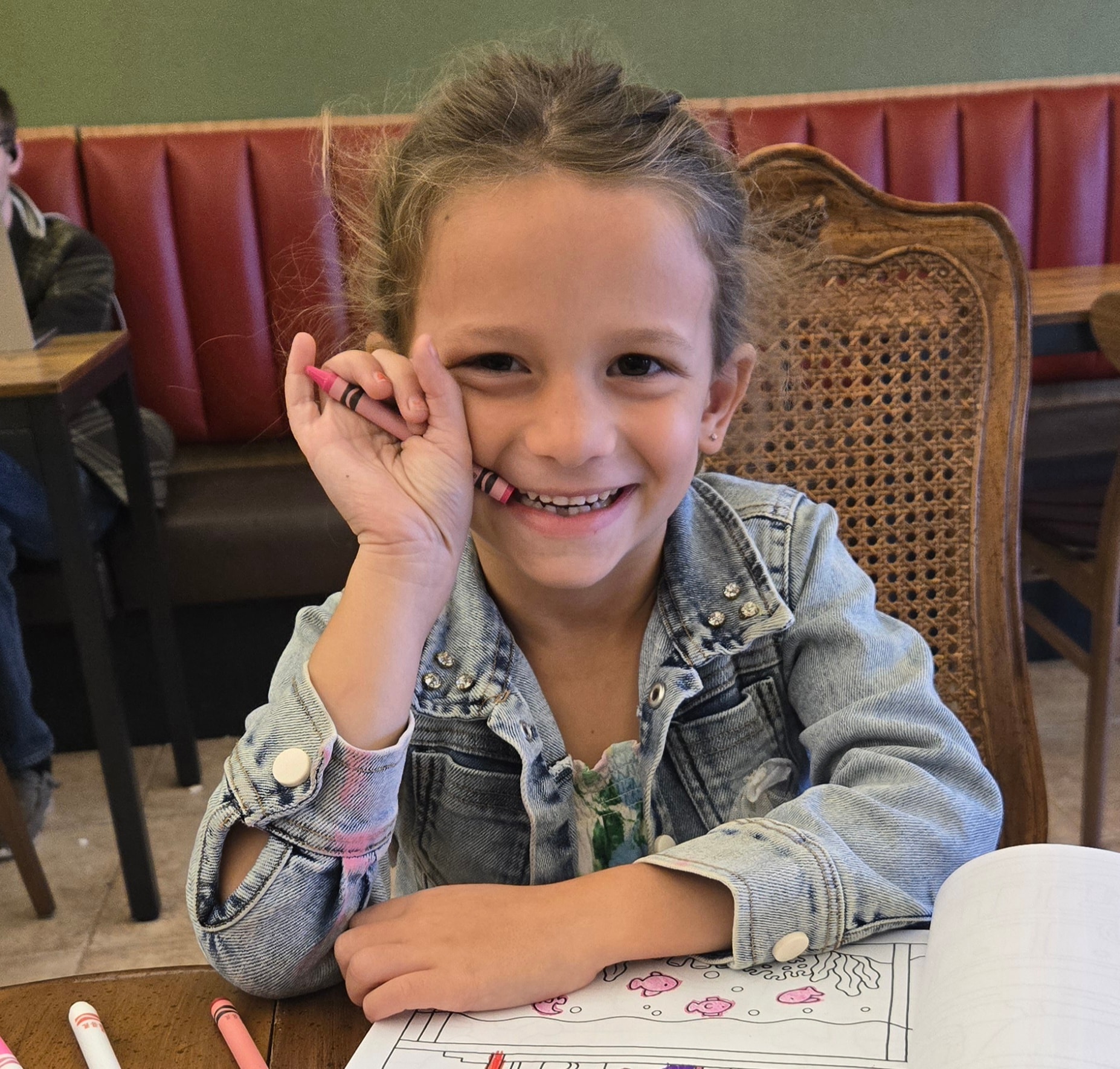 Student at a restaurant table doing schoolwork