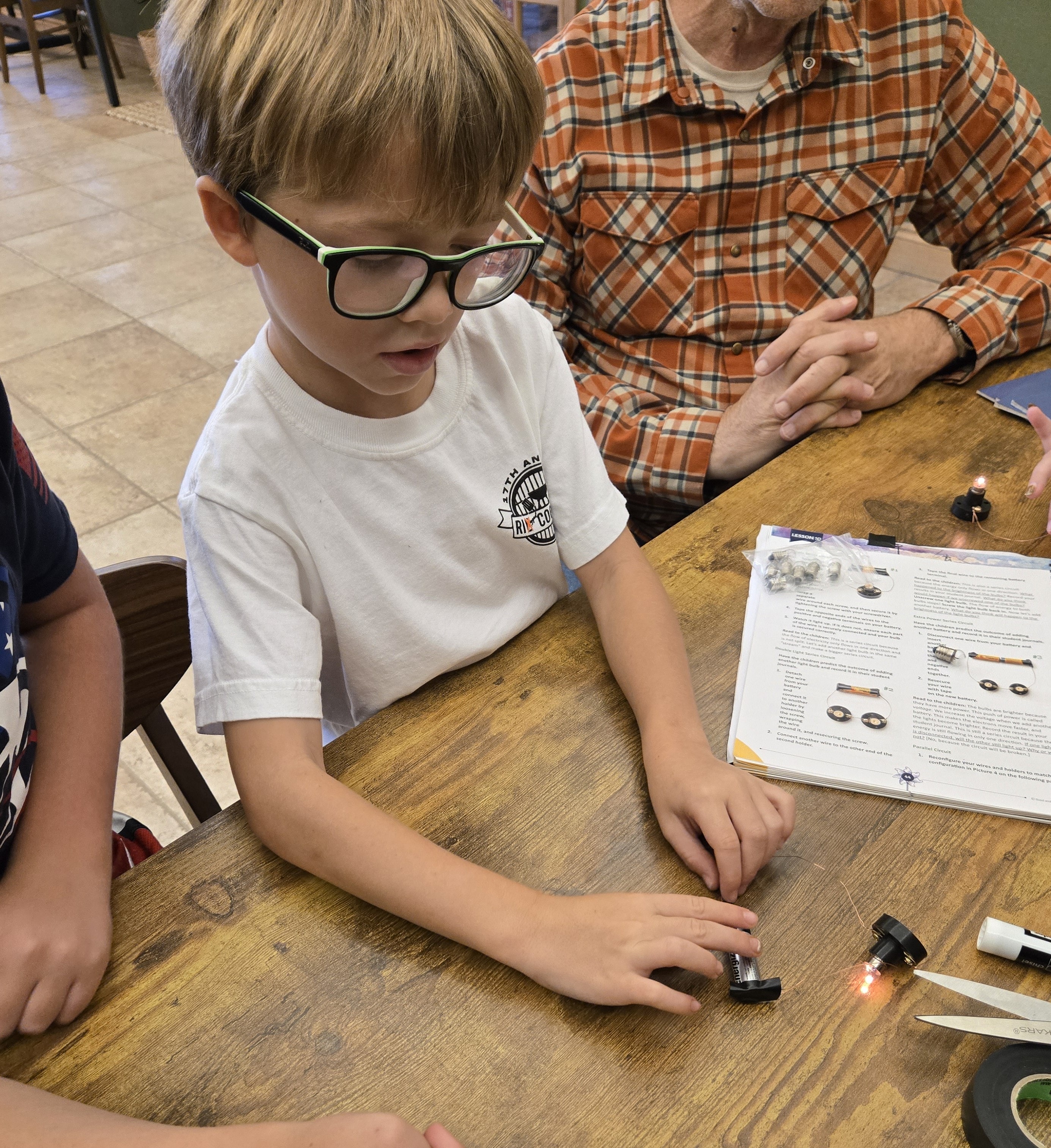 Student and adult doing a hands-on activity