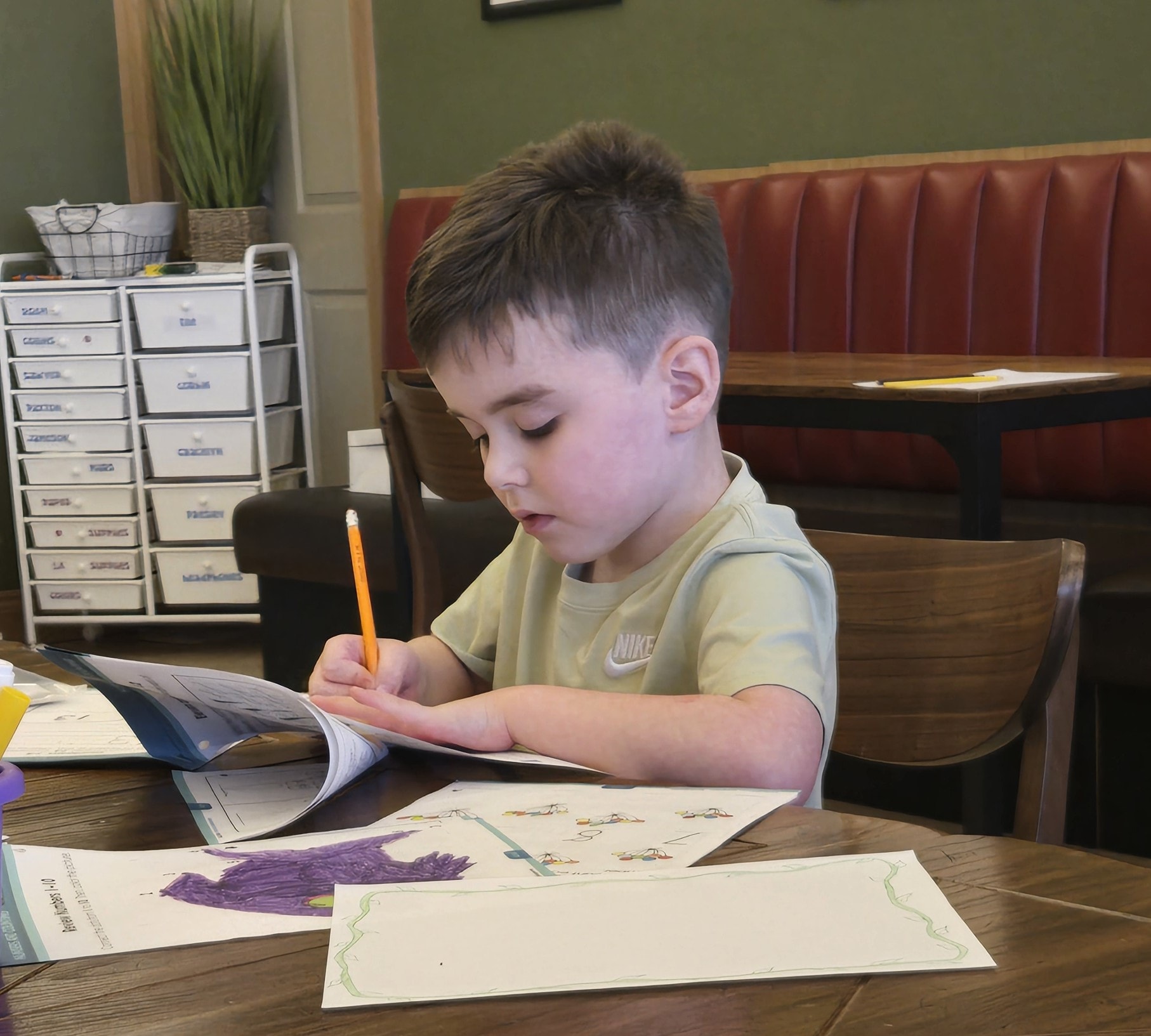 Student drawing at a table